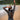 Lady putting on a wetsuit at the beach, mountains in the background