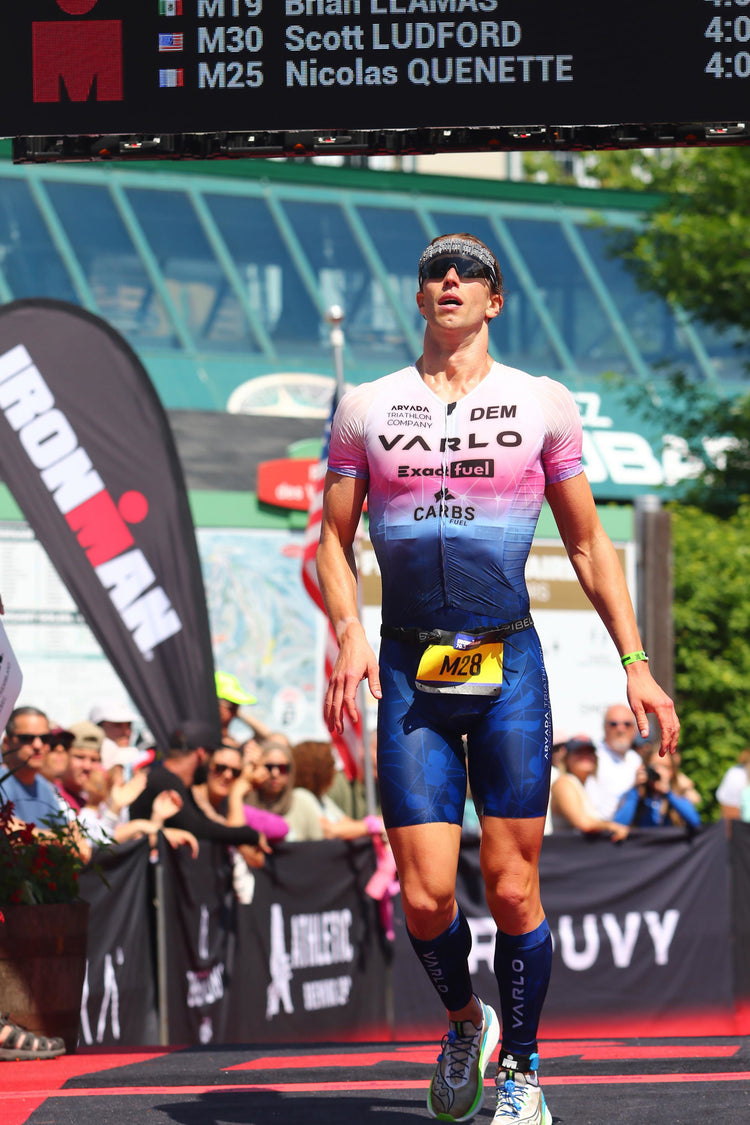 Arvada Triathlon Company athlete crossing an IRONMAN finish line